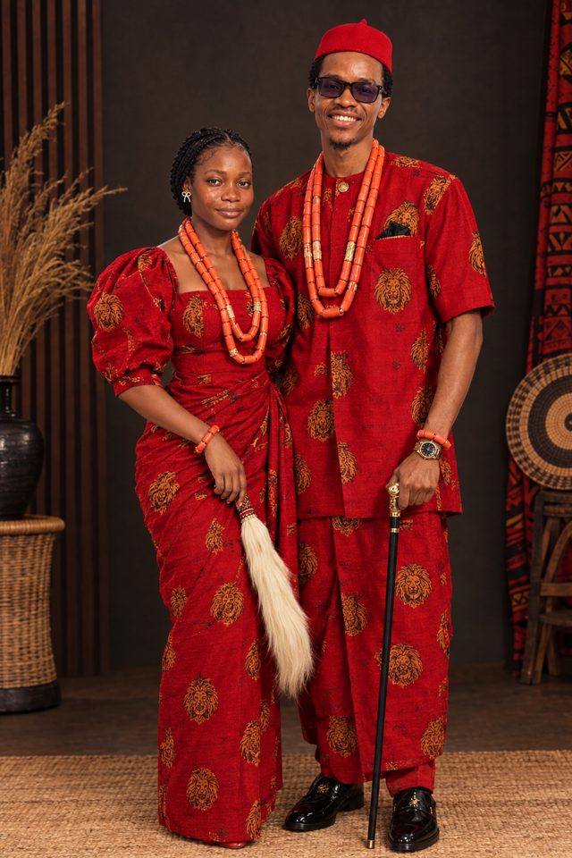 Glory and Precious in matching red traditional attire with coral beads